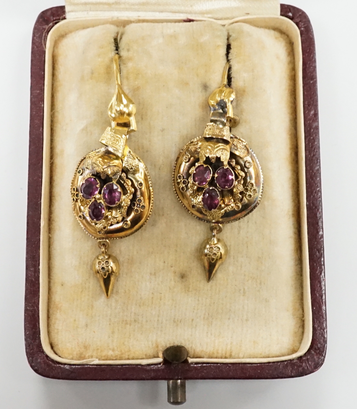A pair of 19th century yellow metal and three stone garnet set drop earrings, overall 40mm, gross weight 3.4 grams.
